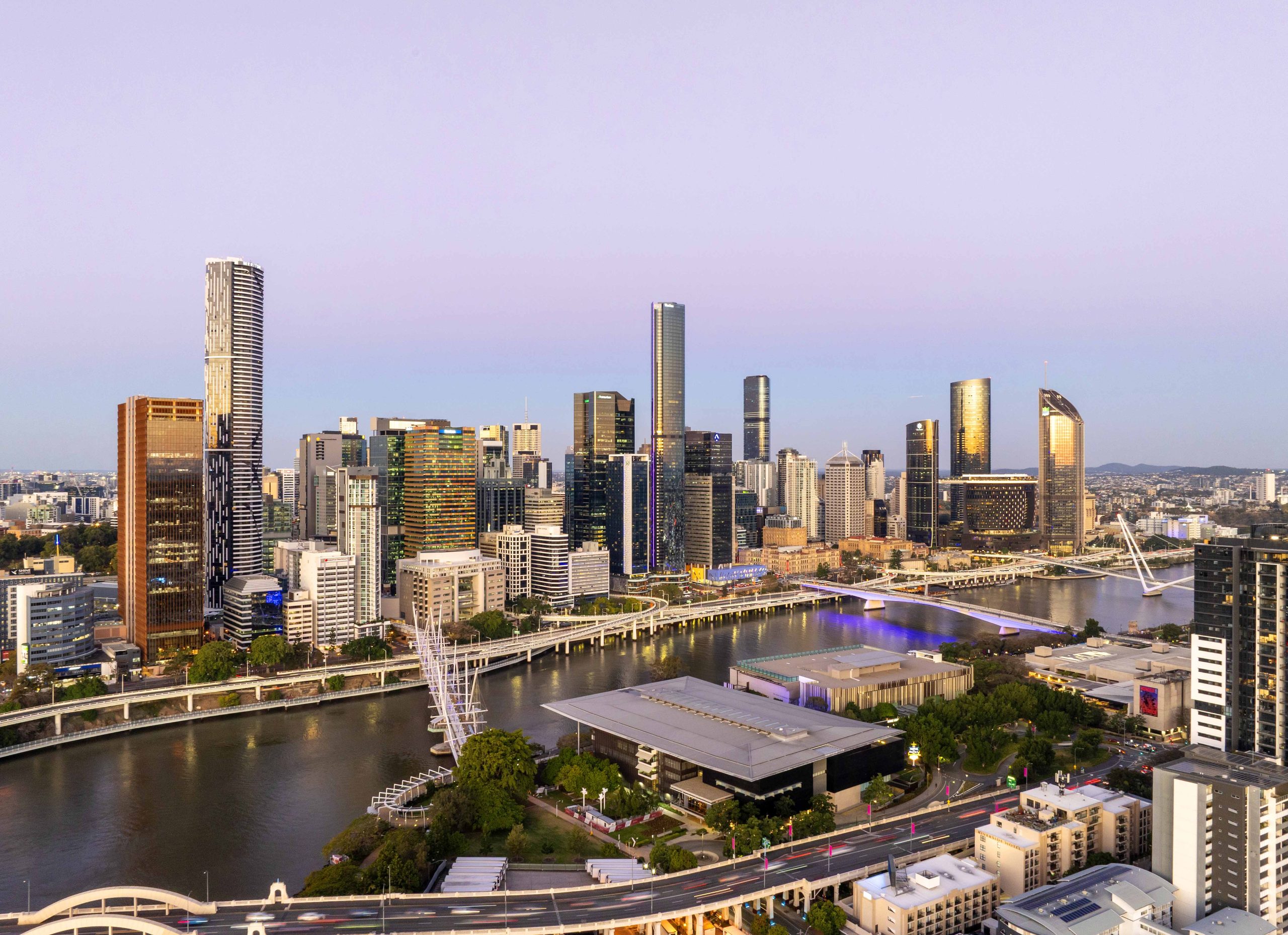 Brisbane city skyline at dusk showing prominent high-rise construction projects and evolving architecture.